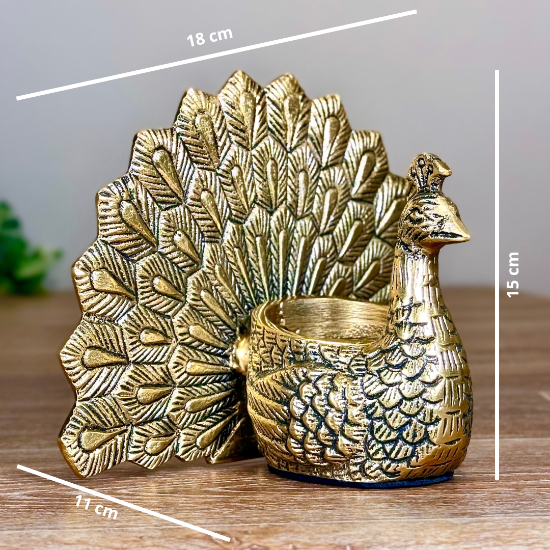 Product image of the Peacock Candle Holder with Antique Brass Finish from Indian Impressions, showcasing a stunning peacock design with intricate detailing and a vintage-inspired finish. Ideal for holding candles, this piece is perfect for Vastu, home décor, festive occasions, or gifting, adding elegance and positive energy to any space.