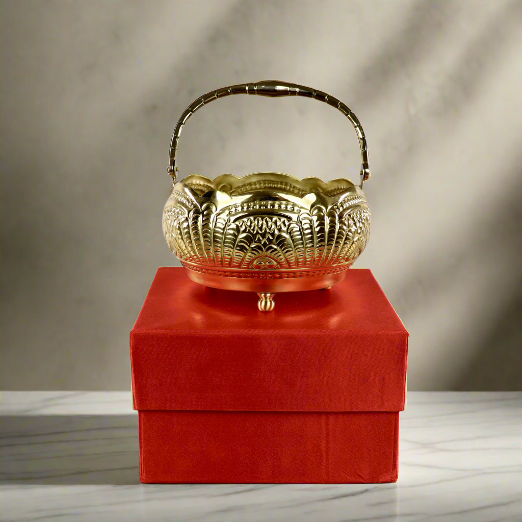 Product image of a Puspam Brass Flower Basket from Indian Impressions, featuring an intricately handcrafted design with traditional motifs. Made from polished brass, this elegant basket is perfect for holding flowers, enhancing Vastu energy, festive décor, or gifting, adding a touch of charm and positivity to any space.