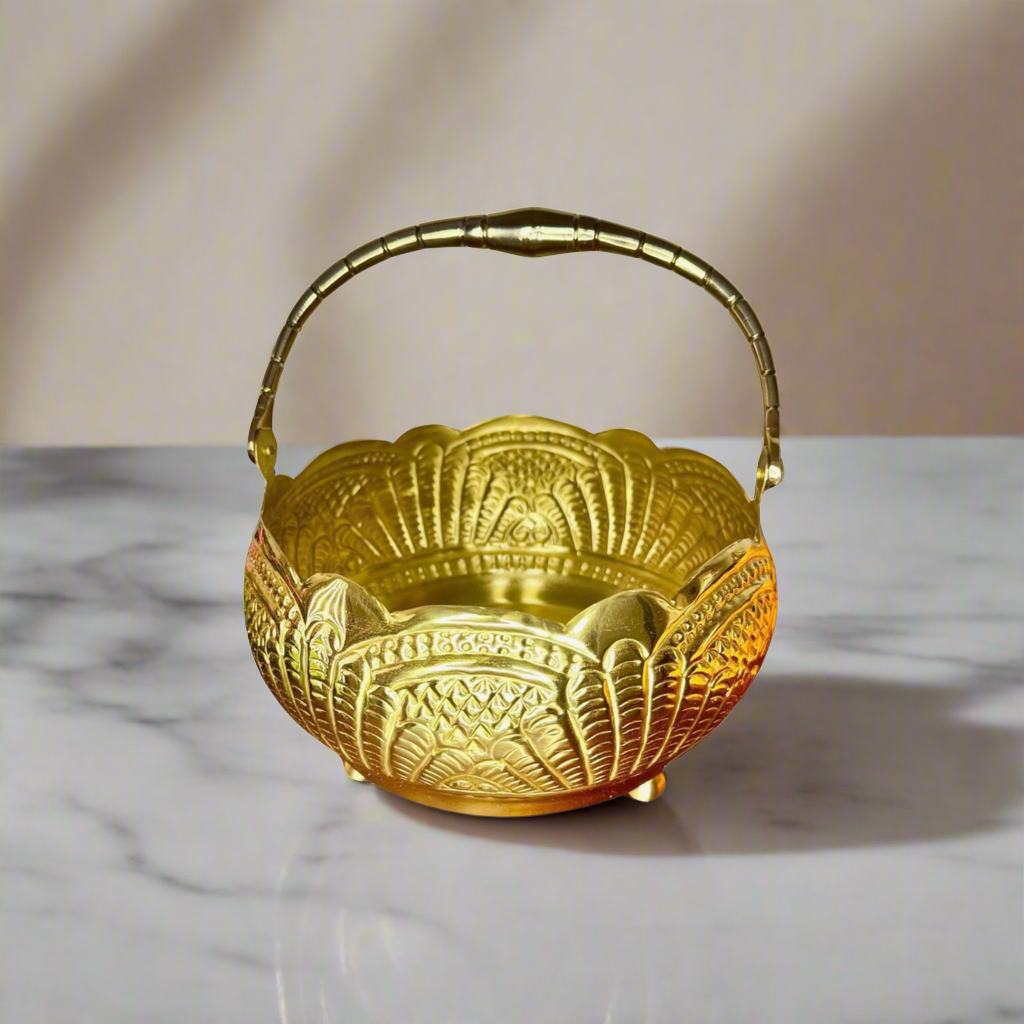 Product image of a Puspam Brass Flower Basket from Indian Impressions, featuring an intricately handcrafted design with traditional motifs. Made from polished brass, this elegant basket is perfect for holding flowers, enhancing Vastu energy, festive décor, or gifting, adding a touch of charm and positivity to any space.