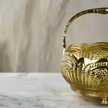 Product image of a Puspam Brass Flower Basket from Indian Impressions, featuring an intricately handcrafted design with traditional motifs. Made from polished brass, this elegant basket is perfect for holding flowers, enhancing Vastu energy, festive décor, or gifting, adding a touch of charm and positivity to any space.