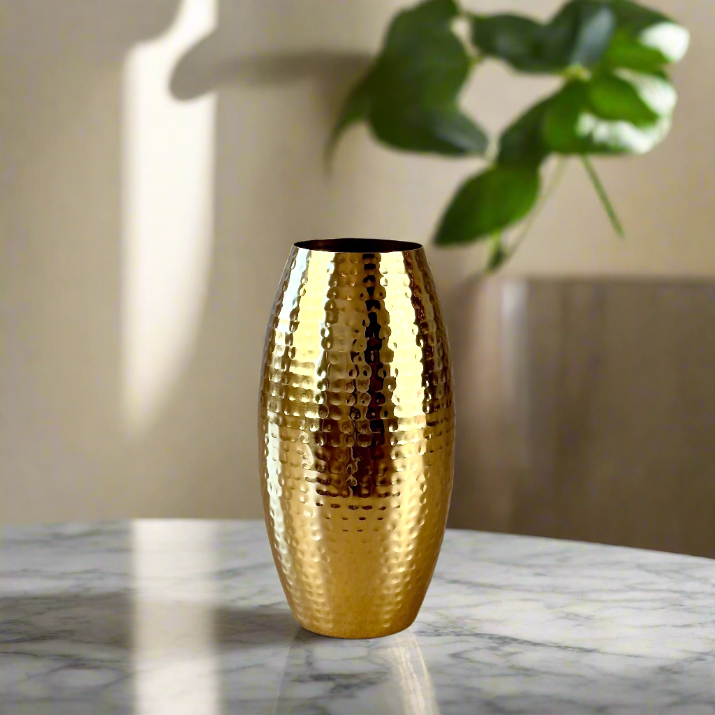 Product image of a Metal Gold Vase from Indian Impressions, featuring a sleek and modern design with a polished gold finish. Perfect as a standalone décor piece or for displaying flowers, this vase adds elegance and sophistication to any space. Ideal for Vastu, home décor, or gifting.