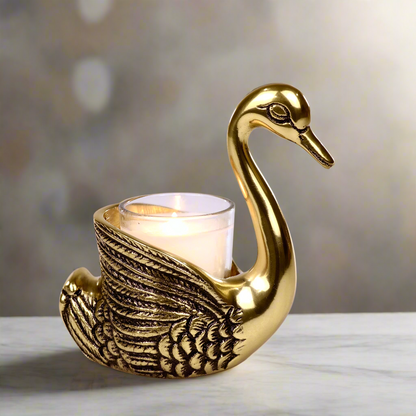 Product image of the Swan Figurine Candle Holder Pair in Gold from Indian Impressions, showcasing two intricately crafted swan-shaped candle holders with a polished gold finish. Ideal for holding candles, this elegant pair is perfect for Vastu, home décor, festive occasions, or gifting, adding sophistication and charm to any space.