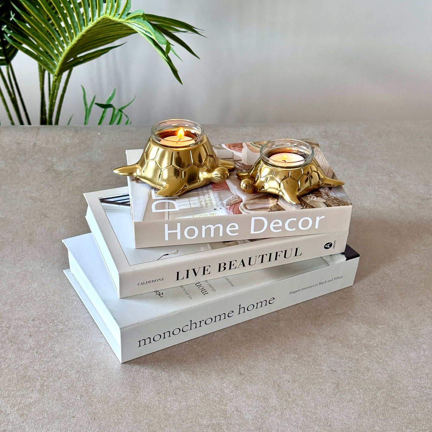 Product image of the Turtle Candle Holder Pair in Gold from Indian Impressions, featuring two beautifully crafted turtle-shaped candle holders with a polished gold finish. Ideal for holding candles, this pair symbolizes stability and longevity. Perfect for Vastu, home décor, or gifting, adding elegance and positive energy to any space.