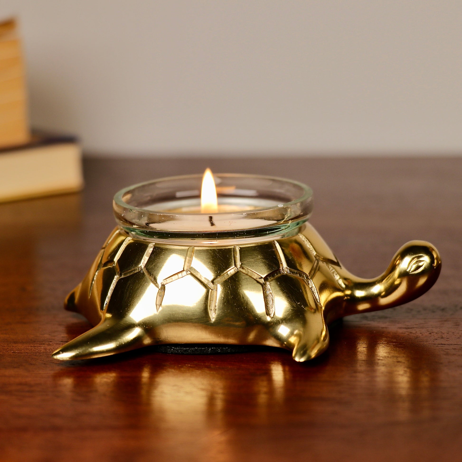 Product image of the Turtle Candle Holder Pair in Gold from Indian Impressions, featuring two beautifully crafted turtle-shaped candle holders with a polished gold finish. Ideal for holding candles, this pair symbolizes stability and longevity. Perfect for Vastu, home décor, or gifting, adding elegance and positive energy to any space.